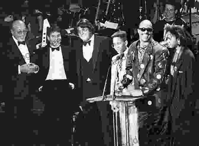 Elton John Standing Proudly In The Rock And Roll Hall Of Fame, Holding An Award Wurlitzer Of Cincinnati: The Name That Means Music To Millions